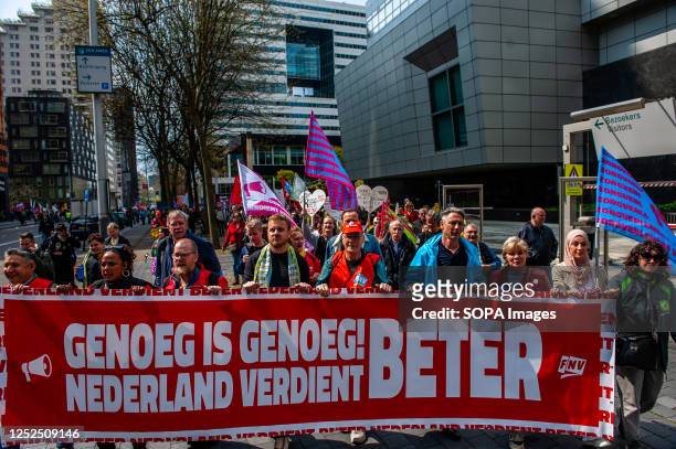 People are seen walking behind the principal banner. On the day of International Workers' Day, also known as Labour Day, in Amsterdam people marched...