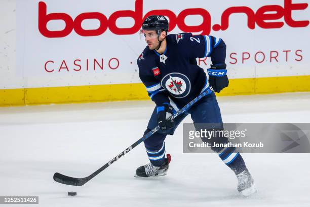 Dylan DeMelo of the Winnipeg Jets plays the puck during third period action against the Vegas Golden Knights in Game Four of the First Round of the...