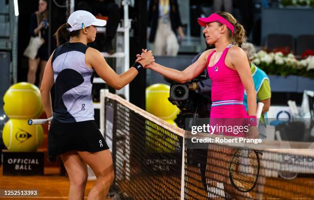 Iga Swiatek of Poland and Ekaterina Alexandrova from Russia shake hands at the net after the fourth round on Day Eight of the Mutua Madrid Open at La...