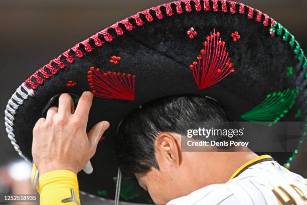 Ha-Seong Kim of the San Diego Padres puts on a sombrero after his three-run home run during the fifth inning against the Cincinnati Reds May 1, 2023...