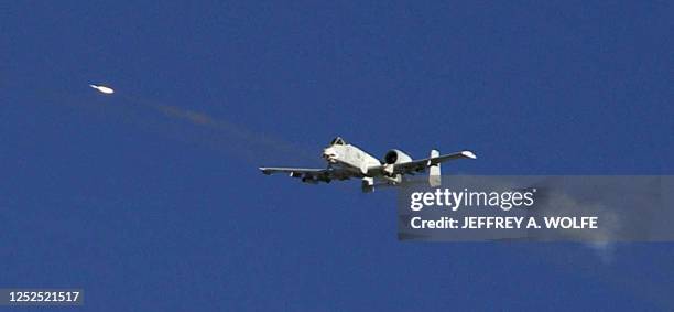 This photo released by the US Department of Defense 18 November shows a US A-10 "Warthog" with the 74th Fighter Squadron firing a rocket at a target...