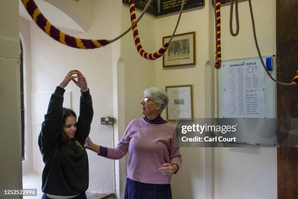 Jen Thomas , the Kent County Association of Change Ringers Youth Officer, assists Year 9 student Florrie Totterdell during a bell ringing practice...