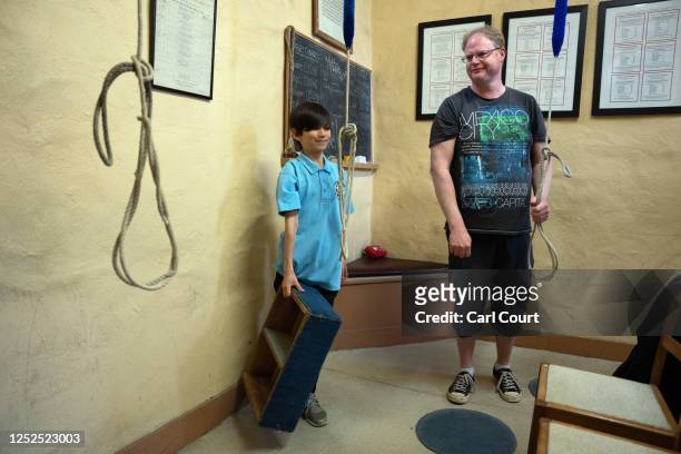Instructor, Nigel Pointer, looks on as 11-year-old Sataryu Blundred moves a box during a bell ringing practice session at Bromley Parish Church on...