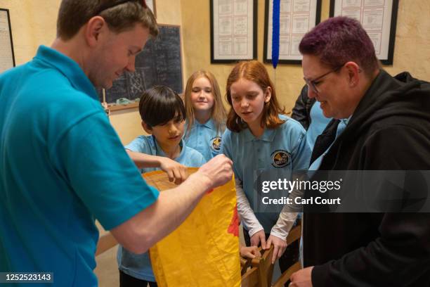 Youngsters grab sweets from a bag at the end of a bell ringing practice session at Bromley Parish Church on April 30, 2023 in Bromley, England....