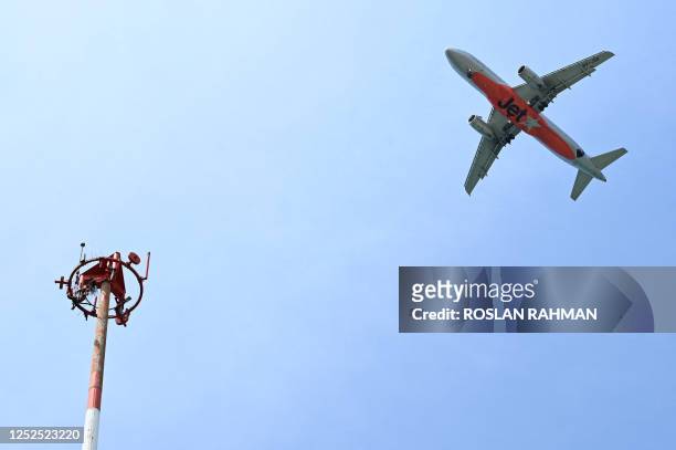 Jetstar commercial passenger jet approaches for landing at Singapore Changi Airport in Singapore on May 2, 2023.
