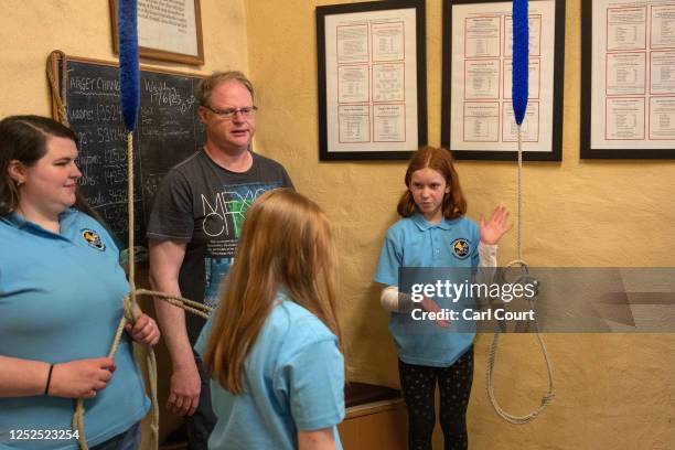 Year-old Hannah Revak-Sebok gestures to 10-year-old Leonie Snee during a bell ringing practice session at Bromley Parish Church on April 30, 2023 in...