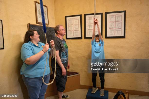Instructors Becca Hardy and Nigel Pointer look on as 11-year-old Sataryu Blundred stretches for a bell-rope during a bell ringing practice session at...