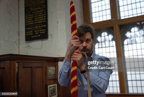 Bell ringer pulls a rope as he takes part in a practice session at Southwark Cathedral on April 12, 2023 in London, England. Throughout Britain plans...