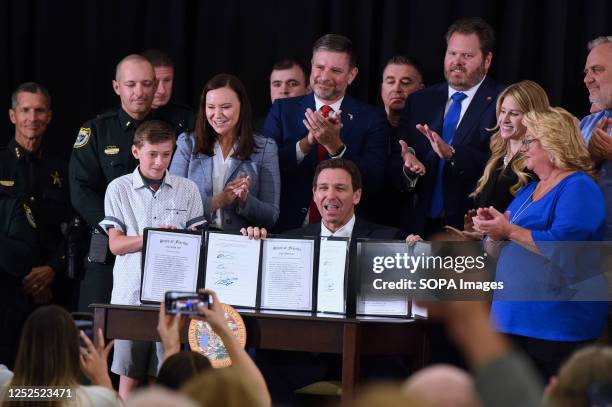Florida Governor Ron DeSantis displays three bills he signed into law at a press conference at the American Police Hall of Fame & Museum in...