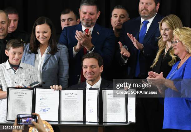 Florida Governor Ron DeSantis displays three bills he signed into law at a press conference at the American Police Hall of Fame & Museum in...