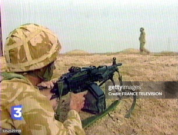 Image taken off French Television France 3 shows an unidentified Iraqi surrendering in southern Iraq as coalition forces enter the region, 21 March...