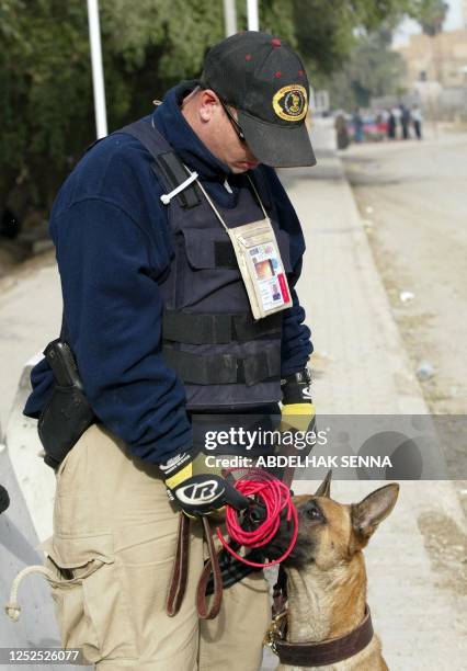 William Brant, a US police officer, holds an explosive detonator found near the entrance of the Sheraton and Palestine hotels 20 December 2003 in...