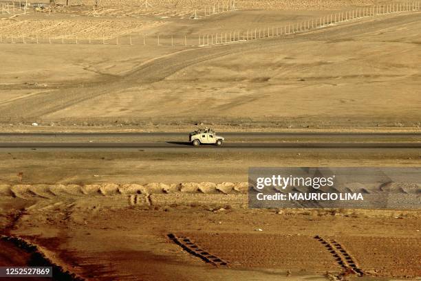 Military Humvee travels down a road towards the northern Iraqi city of Tikrit, 180km north of Baghdad, 03 December 2003. The US Army 4th Infantry...