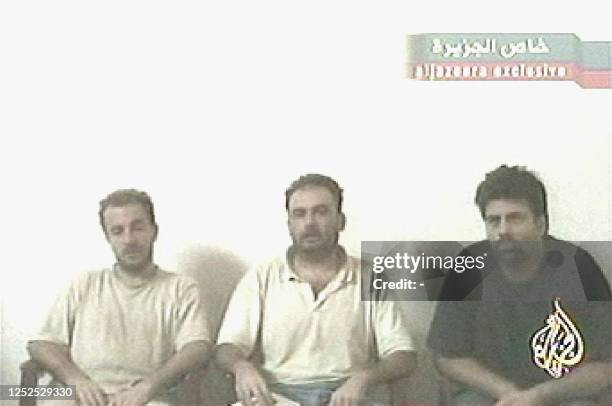 Grab taken 03 June 2004 from the Arabic television station Al-Jazeera shows the three Italian hostages held in Iraq. The kidnappers of the Italians...