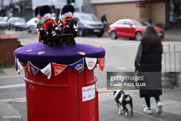 Photograph taken on May 2, 2023 shows a knitted horse-drawn carriage displayed on a post office box next, in Rhyl, north Wales, ahead of the...