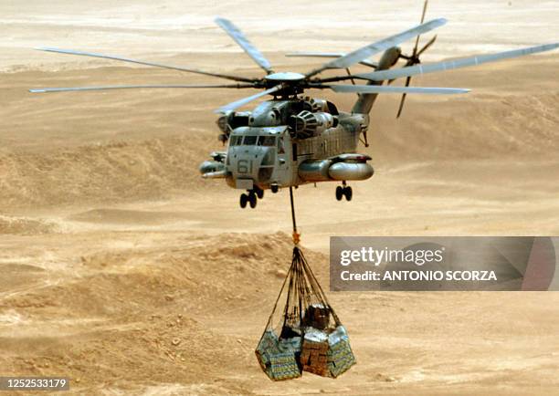 Marine C853 helicopter flies over the desert, 26 May 2004, transporting supplies between Al-Asad airbase and Al-Qaim marine base in the west of Iraq....