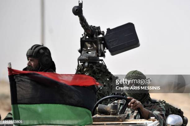 Libyan rebels return from the battle field outside the oil rich town of Ras Lanuf on March 29 as world powers vowed to continue military action until...