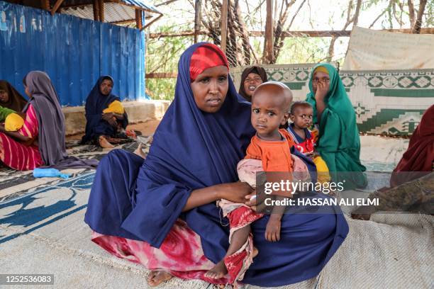 People displaced by drought sit in the shade at the Kabasa nutrition center in Dolow on May 1, 2023.