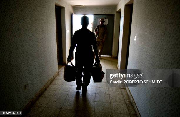 Former Abu Ghraib prisoner walks down a hall to the exit of a local Iraqi Civil Defense Corps camp in the outskirts of Baghdad after he was set free...