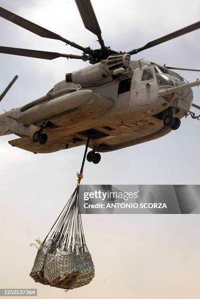 Marine C853 helicopter takes off 26 May 2004, from the al-Asad air base loaded with supplies for the al-Qaim US Marine base in the west of Iraq. US...