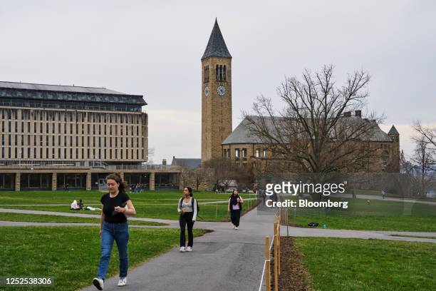 Students walk through the Arts Quad at the Cornell University campus in Ithaca, US, on Tuesday, April 11, 2023. US college costs just keep climbing...