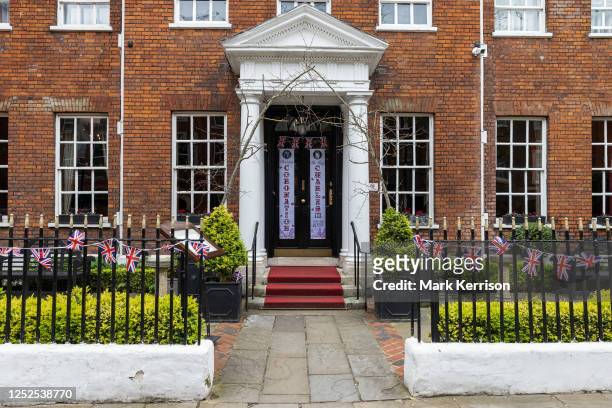 Union Jack bunting is displayed outside a hotel in advance of the coronation of King Charles III on 2 May 2023 in Windsor, United Kingdom. King...