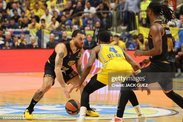 Monaco's US guard Mike James looks to pass the ball past Maccabi's US guard Lorenzo Brown during the Euroleague quarter-final basketball Game 3 match...