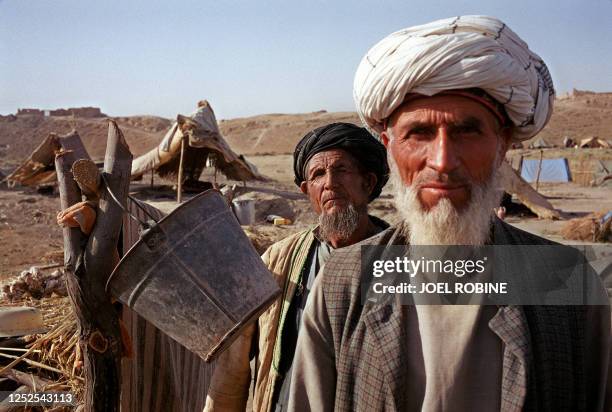 Two elderly Afghan men face photographer end of June 2001 in Lala Guzar refugee camp, in Afghanistan's northeastern Takhar province. This settlement,...