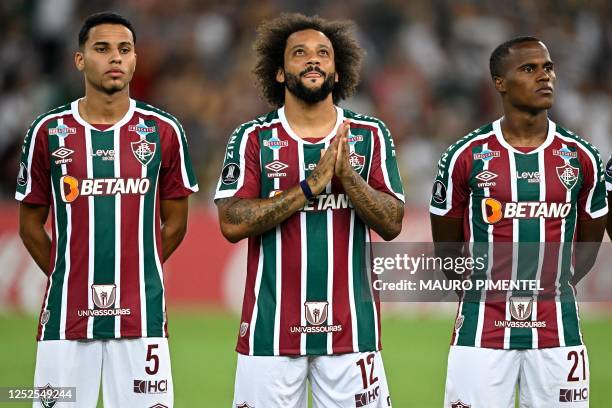Fluminense's midfielder Alexsander, defender Marcelo and Colombian midfielder Jhon Arias listen to the anthems before the Copa Libertadores group...