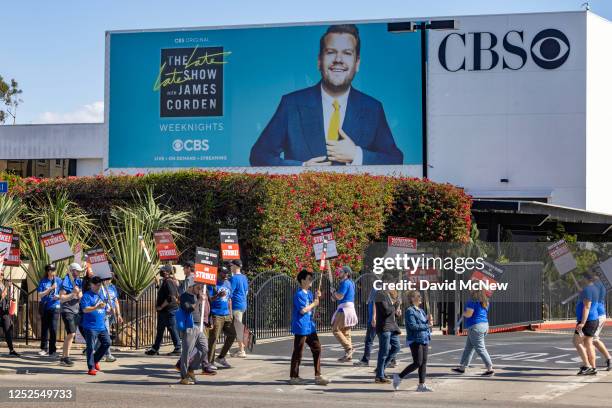 People picket near signage for the Late Late Show with James Cordell outside of CBS Television City on the first day of the Hollywood writers strike...