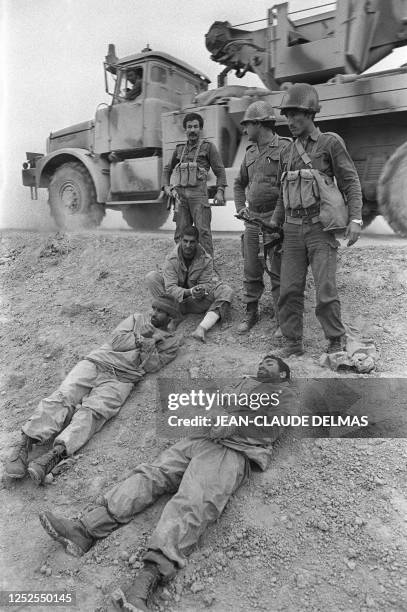 Iraqi soldiers keep a close eye on Iranian prisoners captured on the front line, south east of Tigris, 18 March 1985 during Iraq-Iran war. The...