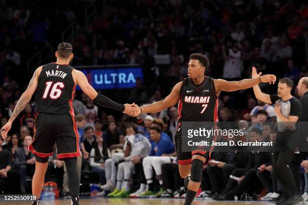Kyle Lowry of the Miami Heat high fives Caleb Martin of the Miami Heat during the game against the New York Knicks during Game Two of the Eastern...