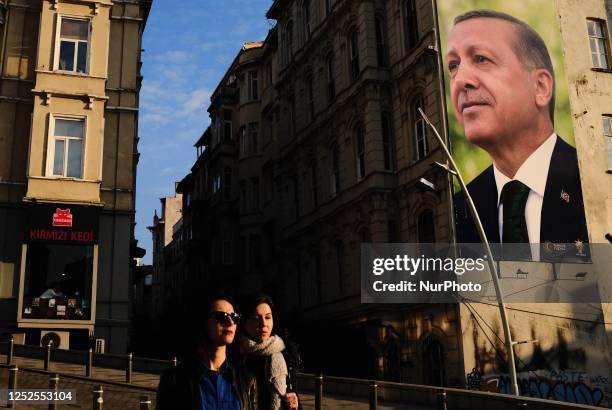 Women are walking past billboards displaying Turkish President and People's Alliance's presidential candidate Recep Tayyip Erdogan, on May 2 in...