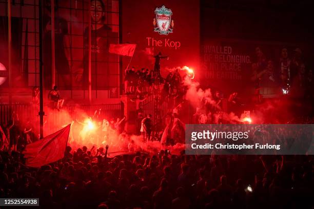 Football fans celebrate at Anfield Stadium as Liverpool FC win the Premier League title after Chelsea beat Manchester City tonight ensuring Liverpool...
