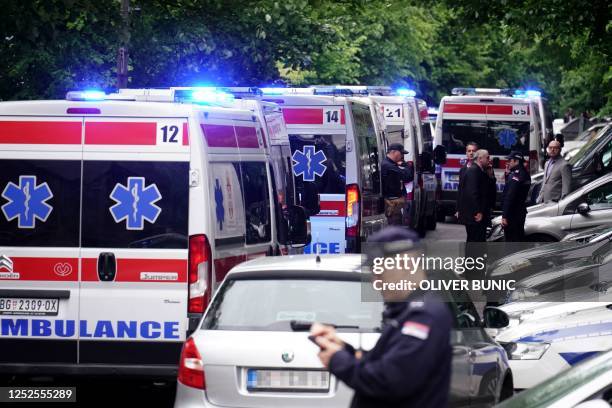 Ambulances and police officers arrive following a shooting at a school in the capital Belgrade on May 3, 2023. - Serbian police arrested a student...