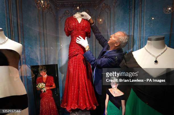 Martin Nolan, director of Julien's Auctions with a scarlet red silk dress , designed by Bruce Oldfield one of three dresses owned by the late Diana,...
