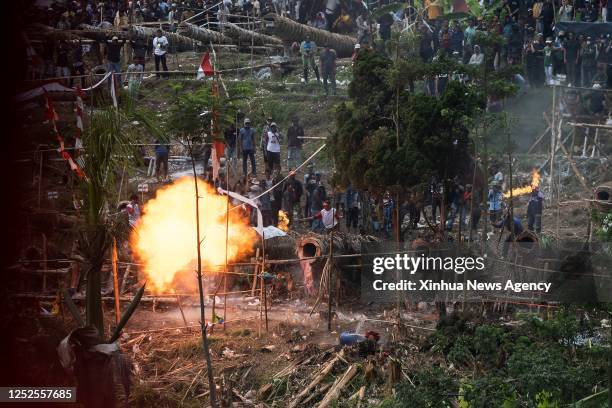 People fire a cannon made of wood during a traditional cannons festival called Kuluwung Bedug Festival in Sukamakmur of West Java province,...