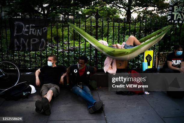 People rest as they take part in a protest encampment near NYC City hall on June 25, 2020 in New York, NY. Similar to the Occupy Wall Street movement...