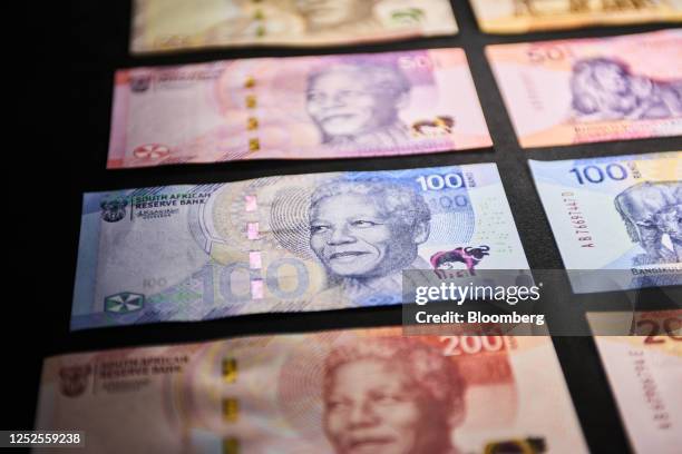 Upgraded South African rand banknotes and coins, featuring former president Nelson Mandela, on display during their launch event in Johannesburg,...