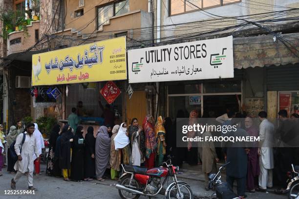 Residents lineup to buy groceries at government rates outside a store in Rawalpindi on May 3, 2023.