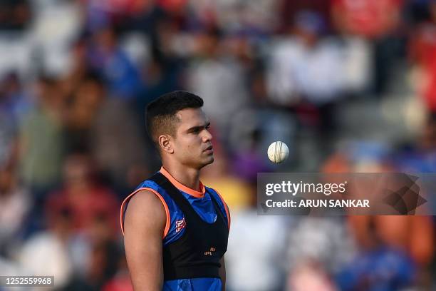 Mumbai Indians' Arjun Tendulkar practices before the start of the Indian Premier League Twenty20 cricket match between Punjab Kings and Mumbai...