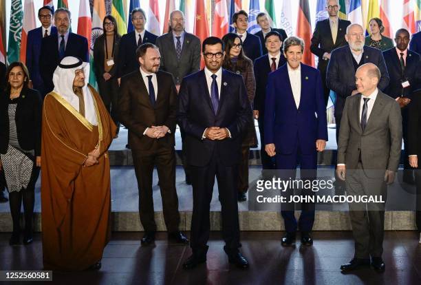 German Chancellor Olaf Scholz glances at the Saudi energy Minister Abdulaziz bin Salman , as Denmark's Minister of Environment Dan Jorgensen , the...