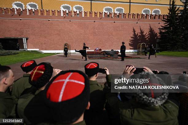 Cossacks watch the changing of honour guards ceremony at the Tomb of the Unknown Soldier by the Kremlin Wall in downtown Moscow on May 3, 2023. - The...