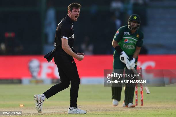 New Zealand's Adam Milne celebrates after taking the wicket of Pakistan's Imam-ul-Haq during the third one-day international cricket match between...