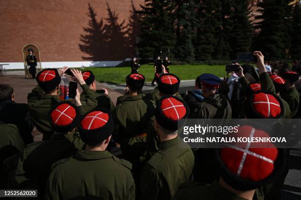 Cossacks watch the changing of honour guards ceremony at the Tomb of the Unknown Soldier by the Kremlin Wall in downtown Moscow on May 3, 2023. - The...