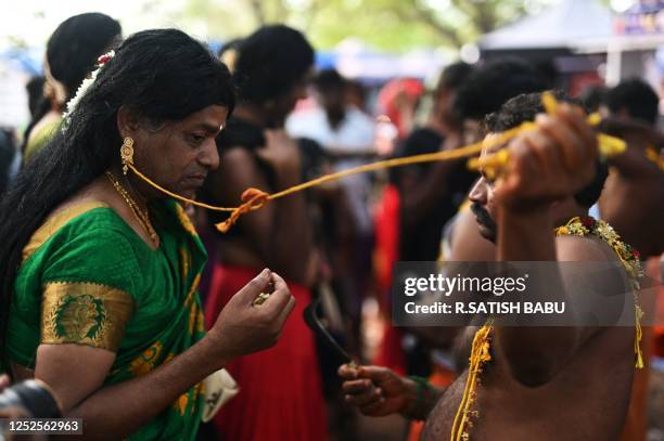 Hindu priest removes the 'thali'- sacred thread -from a member of the transgender community after a priest symbolically behead Hindu warrior god...