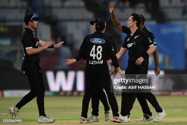 New Zealand's cricketers celebrate after the dismissal of Pakistan's Agha Salman during the third one-day international cricket match between...