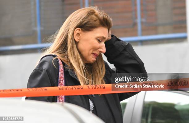 Family members wait outside the 'Vladislav Ribnikar' elementary school on May 3, 2023 in Belgrade, Serbia. At least eight students and a security...