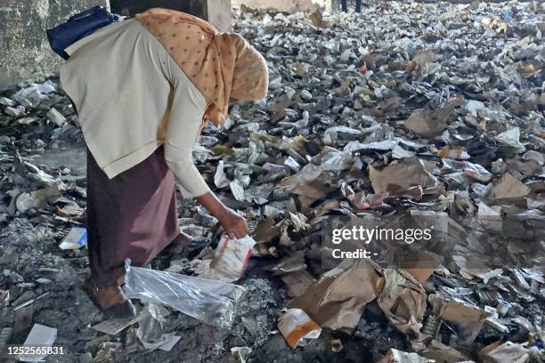Woman inspects a destroyed medical storage in Nyala, the capital of South Darfur province, on May 2, 2023 as deadly clashes between rival generals'...