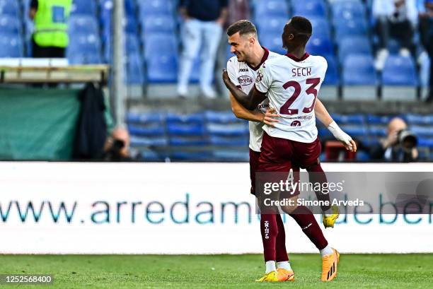 Alessandro Buongiorno of Torino celebrates with his team-mate Demba Seck after scoring a goal during the Serie A match between UC Sampdoria and...